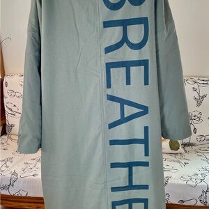 Light Sage Green Coat with Vertical 'BREATHE' Graphic On Back